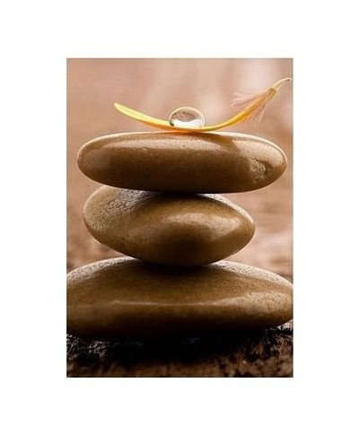 Pile of brown massage stones on wooden background - reprodukcja